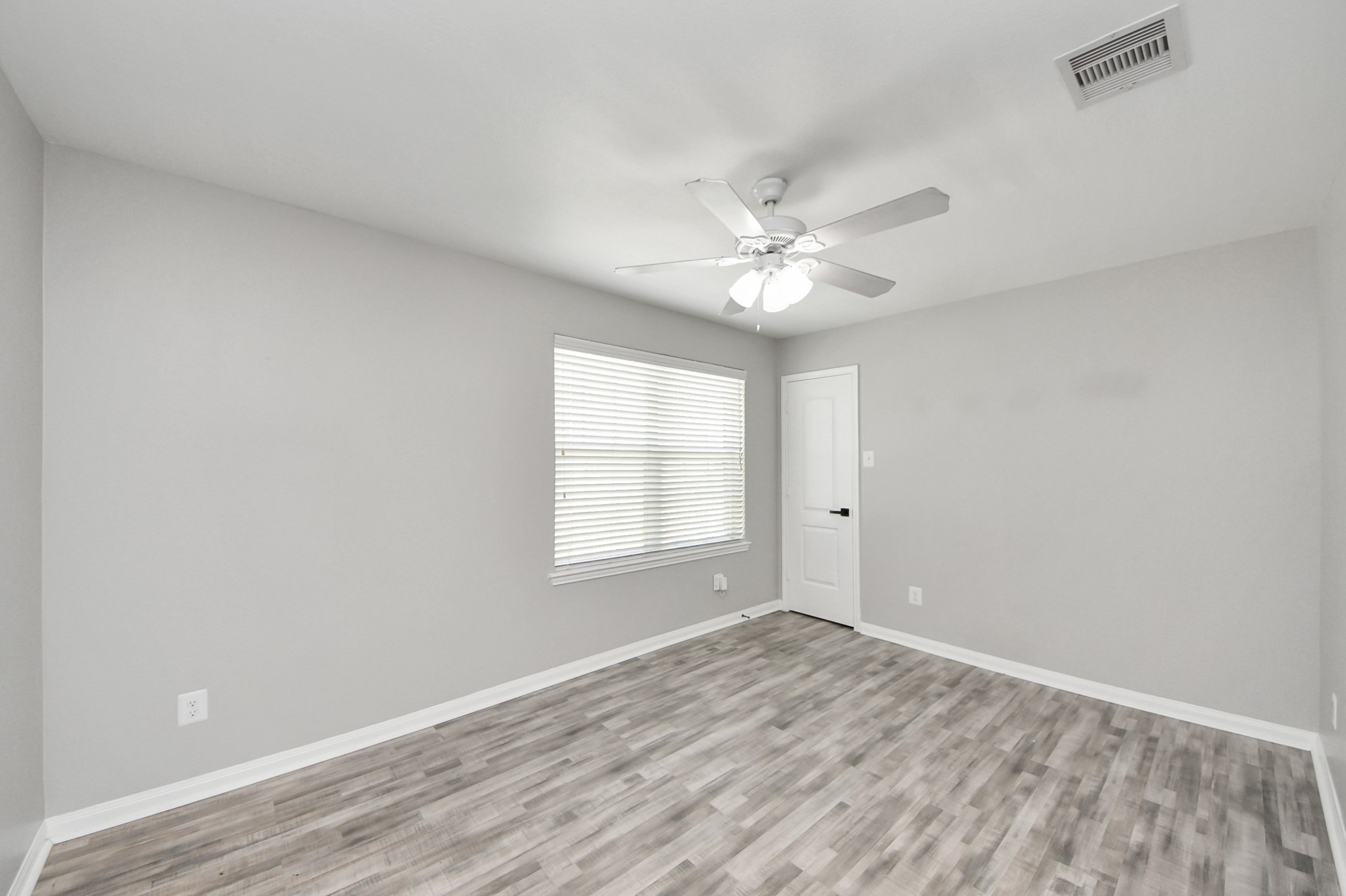 6931 Primrose Road Baytown, TX 77521 - Photo 42 of 50 Bright 5th bedroom featuring large window, ceiling fan, and stylish wood-look flooring