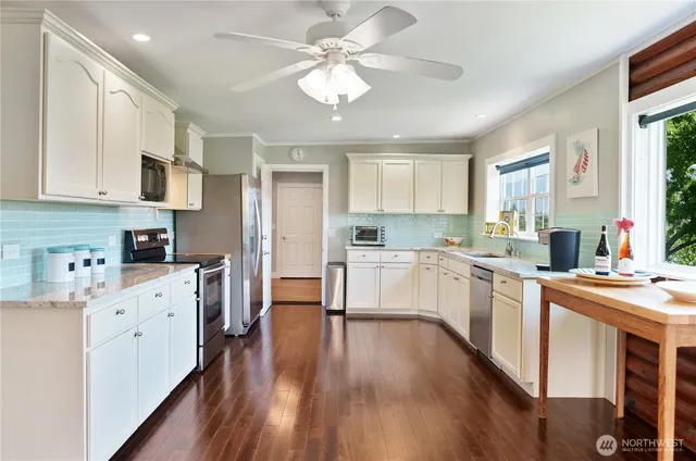 a kitchen with stove a sink and refrigerator