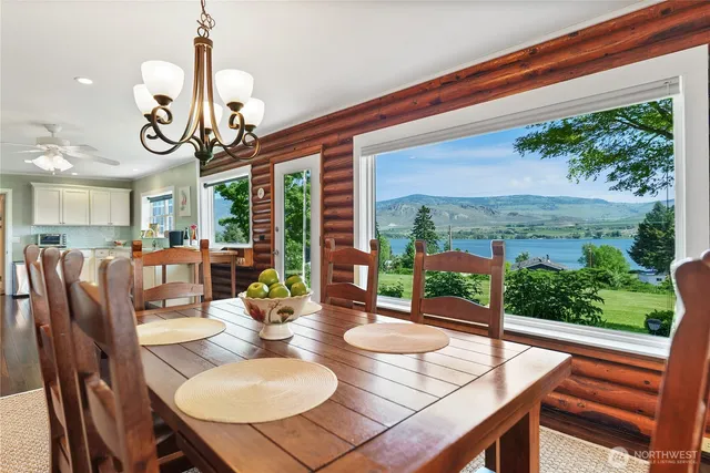 a view of a dining room and hall with furniture
