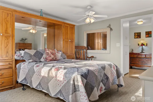 a bedroom with a large bed and a chandelier