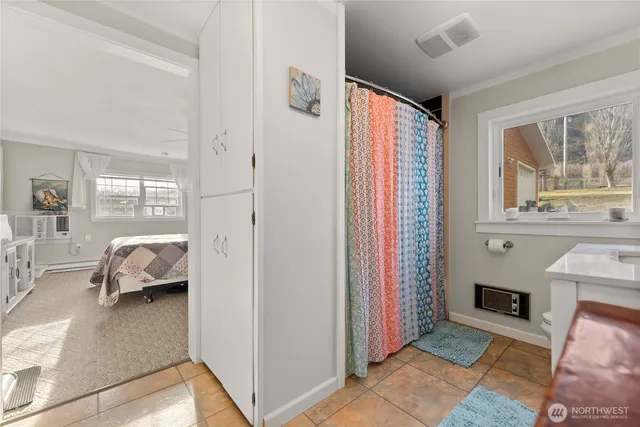 a bedroom with furniture and a window