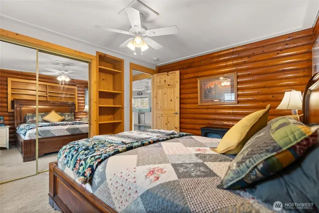 a bedroom with a bed next to a large window with the outer view