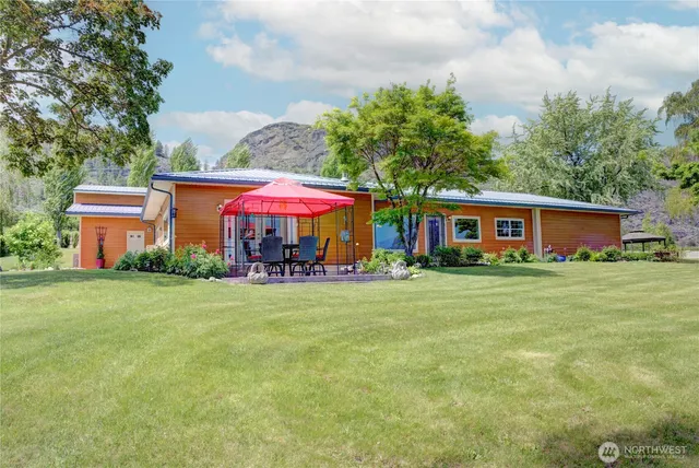 a view of a house with a yard and sitting area