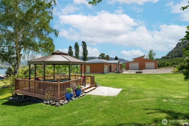 a view of a deck with a table and chairs under an umbrella