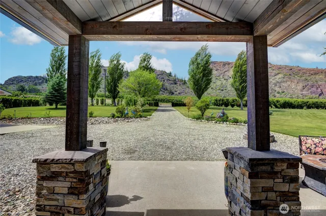 a view of a porch with furniture and a yard