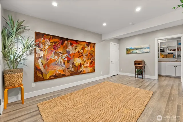 a view of empty room with furniture and wooden floor