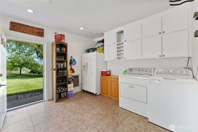 a view of storage and utility room with washer and dryer