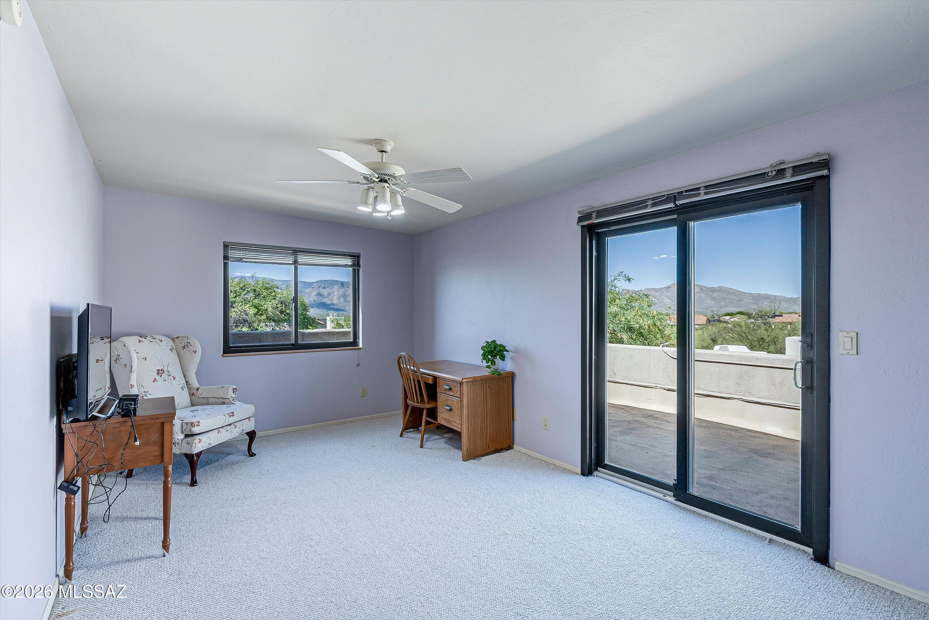 100 North Eastern Slope Loop Tucson, AZ 85748 - Photo 25 of 37 The last bedroom upstairs is very spacious with a walk-in closet and a balcony of its own with gorgeous views of both the Catalina and the Rincon Mountains.