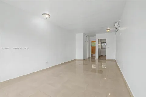 a view of an empty room with a kitchen