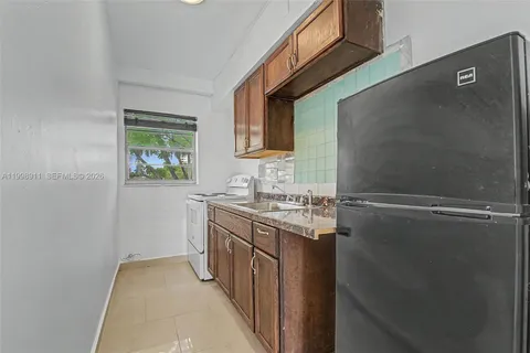 a kitchen with a sink and a refrigerator