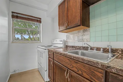 a kitchen with a sink stove and cabinets