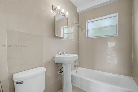 a bathroom with a sink a toilet and bathtub