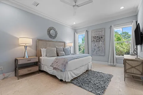 a bedroom with a bed lamp and a rug