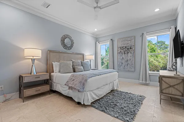 a bedroom with a bed lamp and a rug