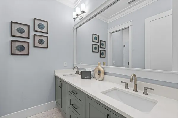 a bathroom with a double vanity sink and a mirror