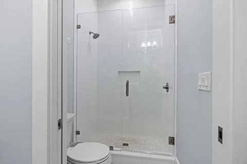 a bathroom with a shower and toilet