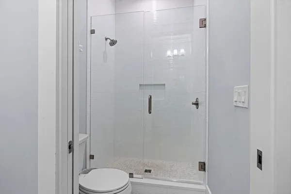 a bathroom with a shower and toilet