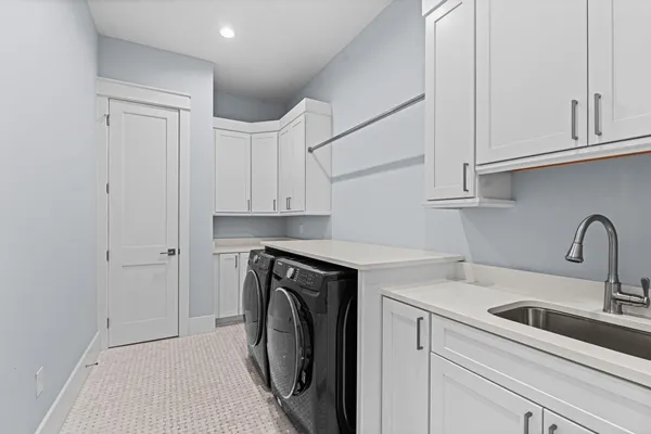 a utility room with sink dryer and washer
