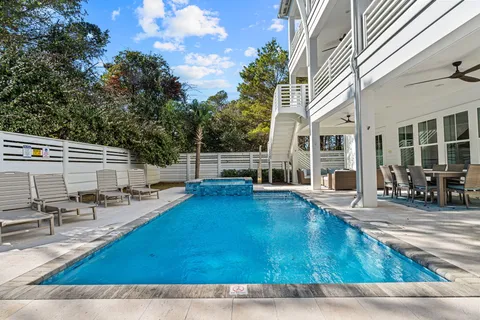 a view of a house with pool porch and sitting area