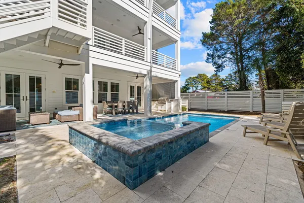a view of a house with swimming pool and sitting area