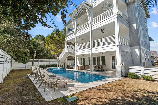 a view of a house with backyard and sitting area