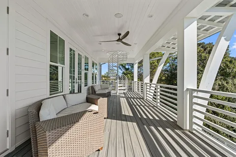 a balcony with wooden floor and furniture