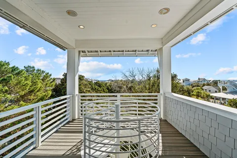 a view of a balcony with floor to ceiling windows with wooden floor
