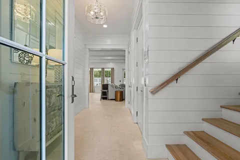a view of a hallway with wooden floor and entryway