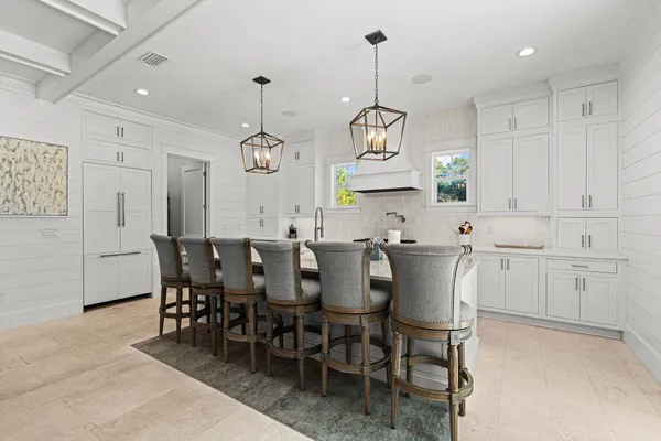a view of dining table chairs and window