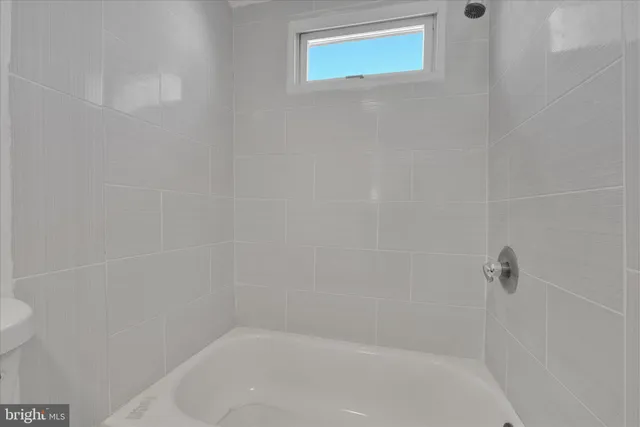 a bathroom with a toilet sink vanity and mirror