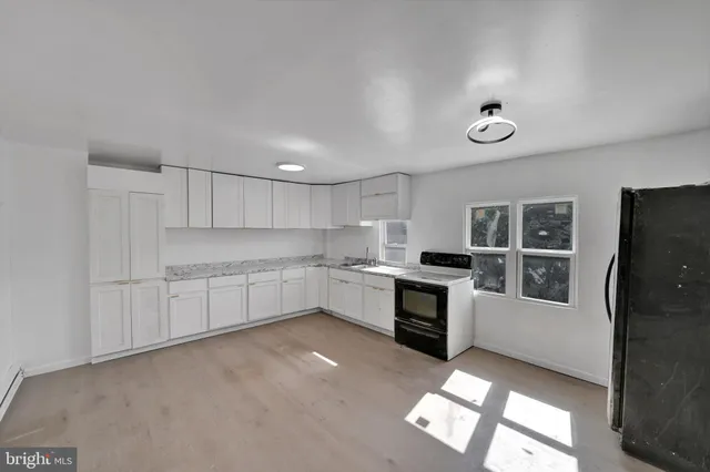 a view of a kitchen with a sink and dishwasher cabinets