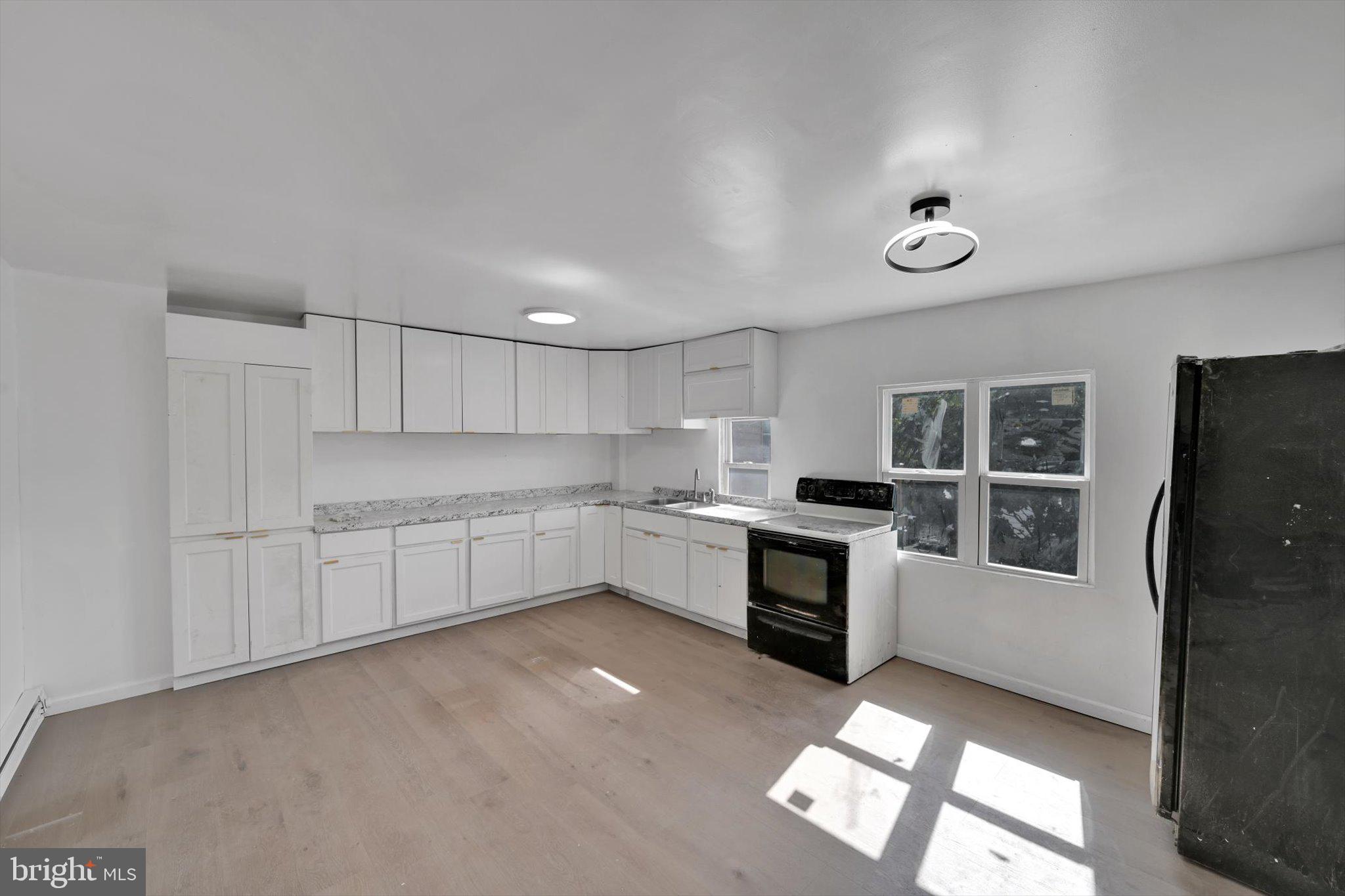 262 Brown Street Tamaqua, PA 18252 - Photo 7 of 21 a kitchen with granite countertop white cabinets and white appliances