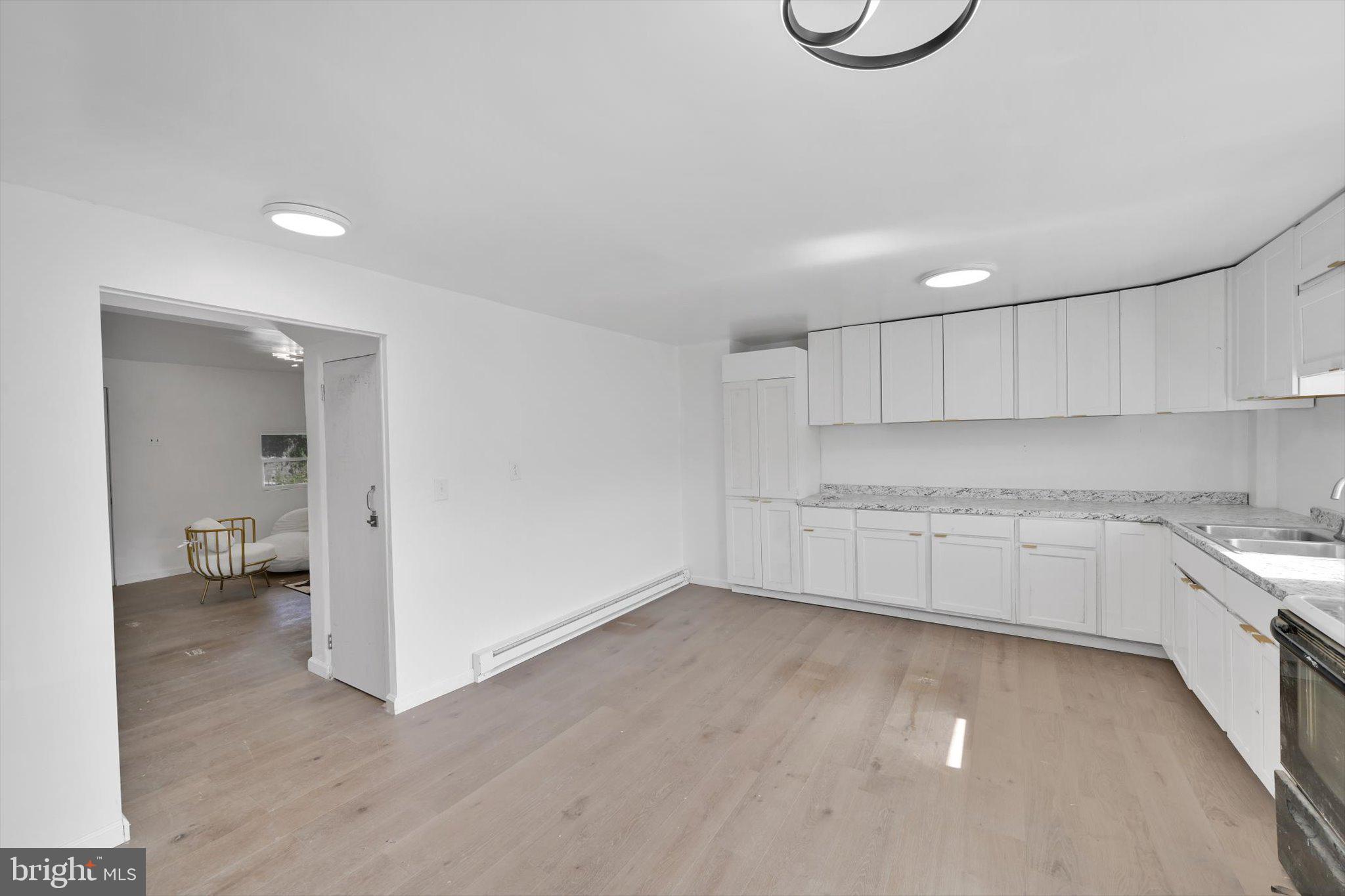 262 Brown Street Tamaqua, PA 18252 - Photo 8 of 21 a view of a kitchen with a sink and dishwasher cabinets