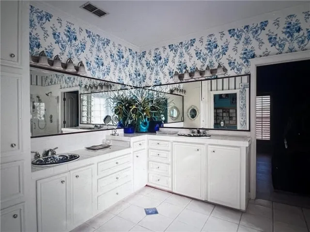 a bathroom with a granite countertop sink vanity and mirror