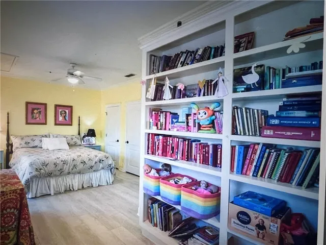 a bedroom with furniture book shelf and a book shelf
