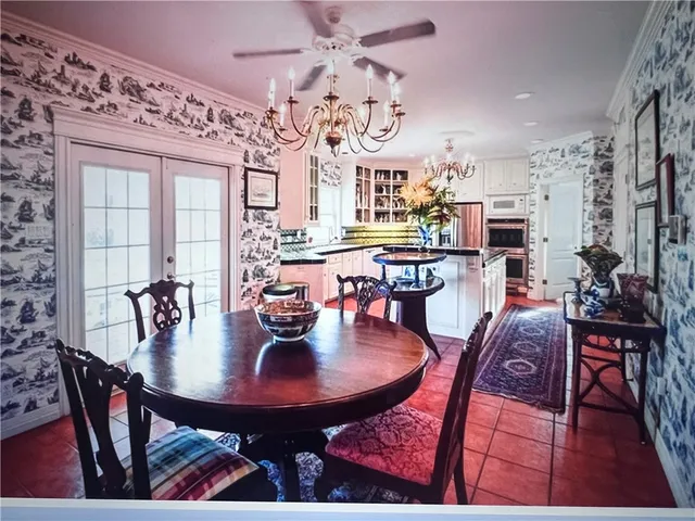 a view of a dining room with furniture and chandelier