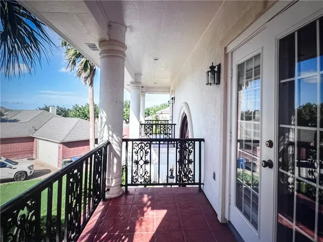 a view of a house with balcony and furniture