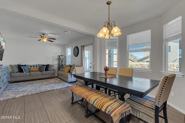 a kitchen with a dining table chairs stainless steel appliances and cabinets