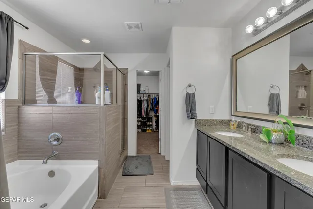 a bathroom with a bathtub and mirror
