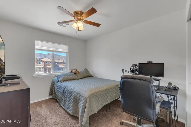 a bathroom with a granite countertop sink and a large mirror