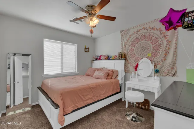 a view of walk in closet with clothes