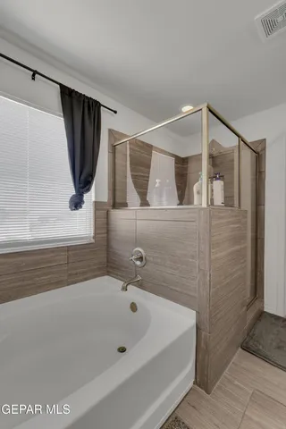 a bathroom with a granite countertop sink double vanity and a mirror