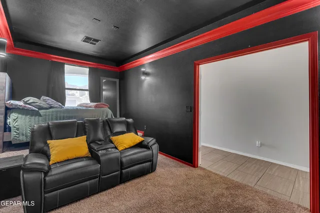 a bedroom with two beds and a flat screen tv