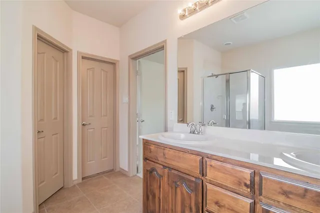 a bathroom with a double vanity sink and a mirror
