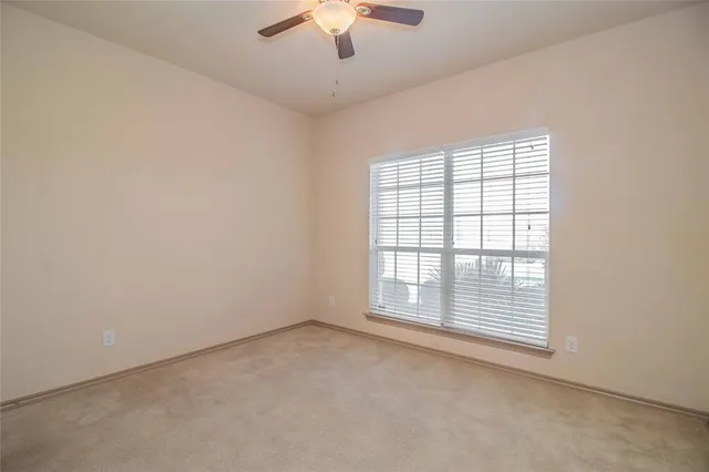 an empty room with a empty space and a ceiling fan