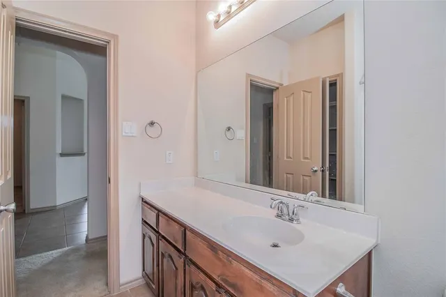 a bathroom with a sink a mirror and a vanity