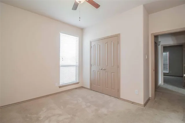 an empty room with windows and closet