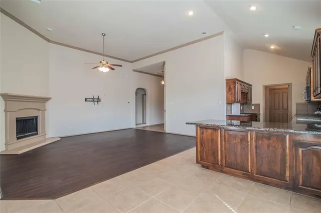 a large kitchen with stainless steel appliances granite countertop a stove and a sink with cabinets