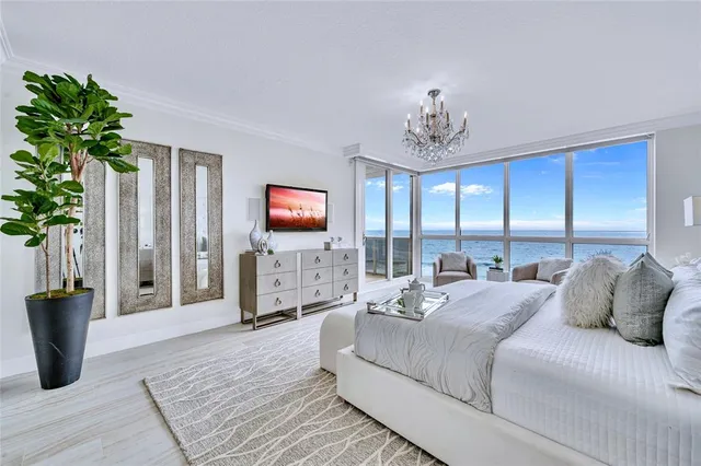 a bedroom with a balcony a bed and a television