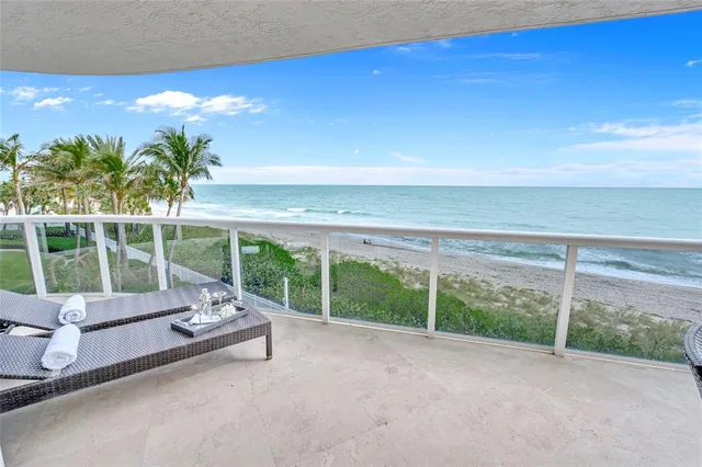 a swimming pool with outdoor seating and yard